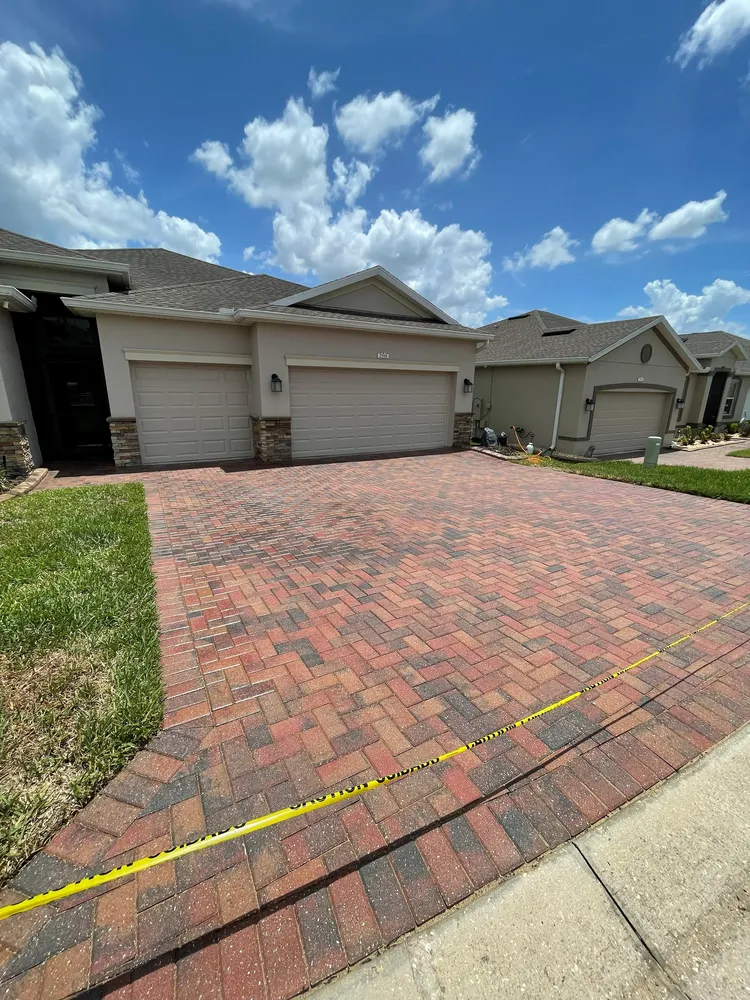 Brick paver driveway after semi-gloss sealing, rich red color, Polk County FL