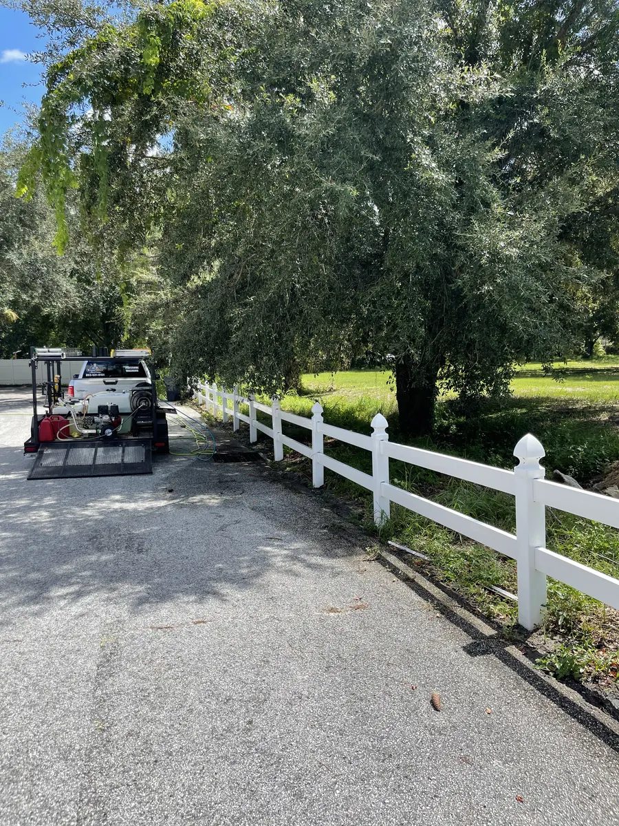 Clean split rail fence after pressure washing — Regal Rinse truck on site