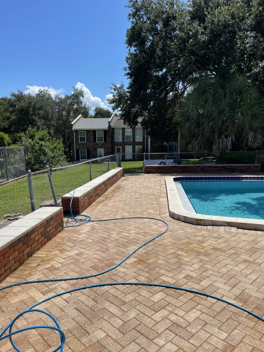 Pool deck pavers after pressure washing — fresh and clean result