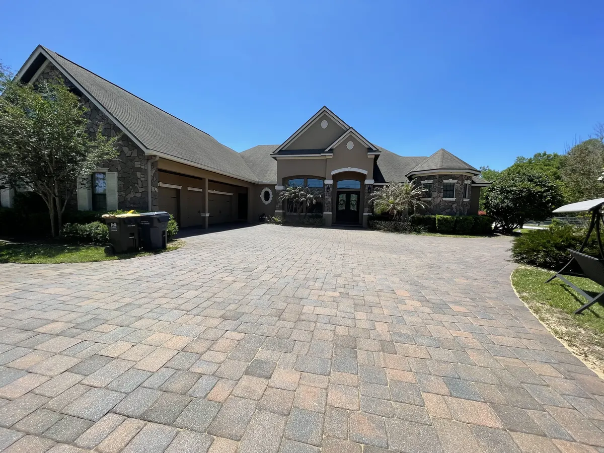 Wide luxury home paver driveway after professional clean and seal service — Polk County FL