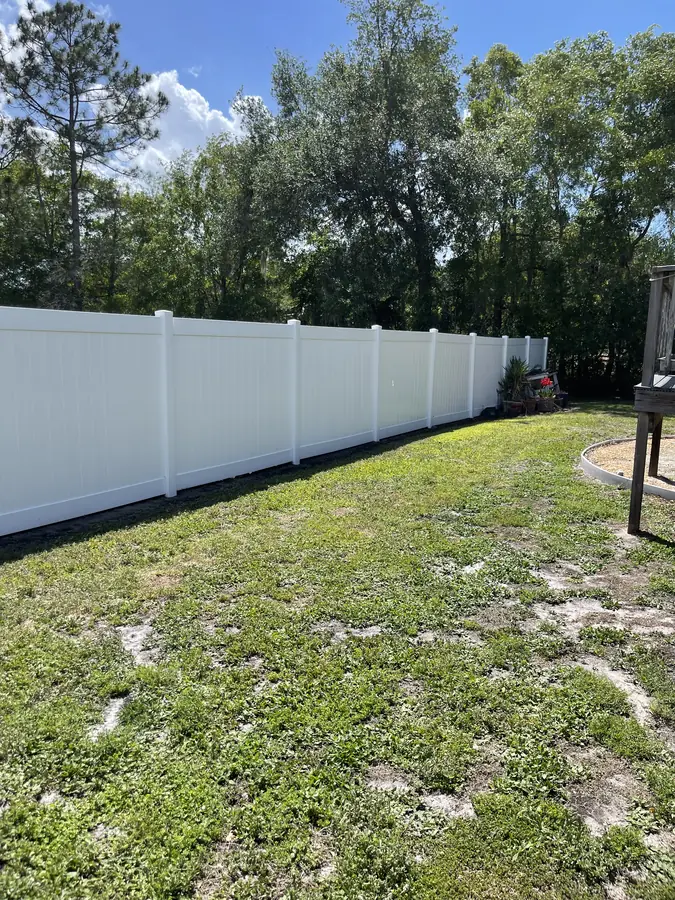 Vinyl privacy fence after soft washing — bright white restored, Polk County FL