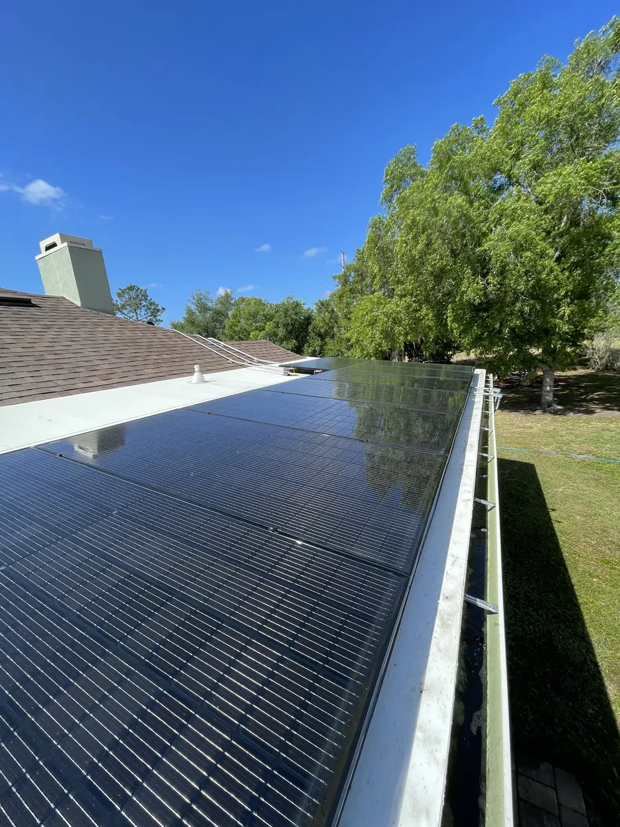Clean solar panel array on flat roof — maximum efficiency restored, Polk County FL